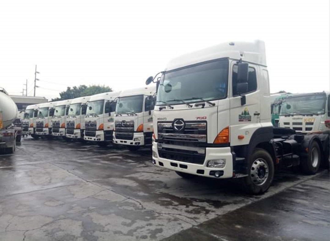 Koinonia's fleet of heavy trucks at a logistics compound